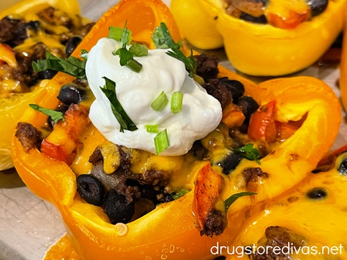 A taco stuffed pepper half with sour cream and cilantro on top.