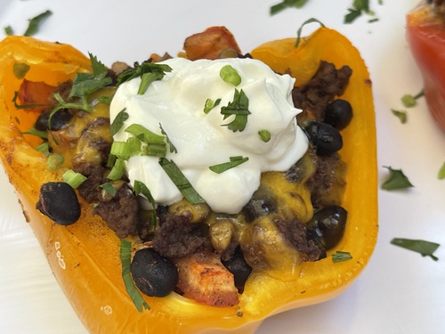 Stuffed pepper halves on a silver tray.