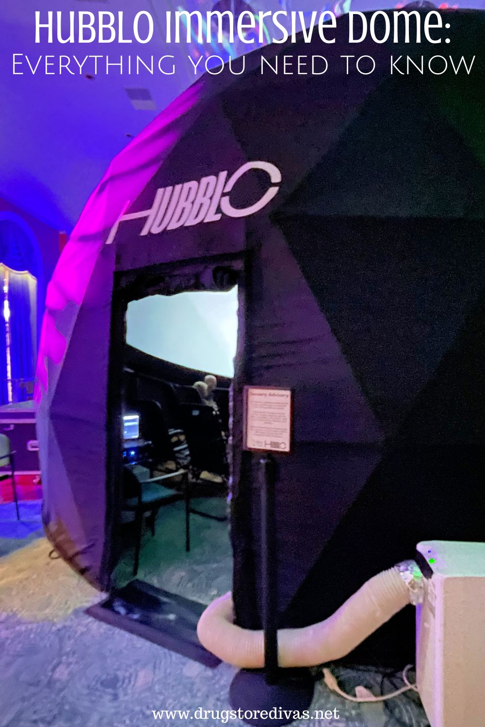 A large, black dome inside a room at a theater with the words 