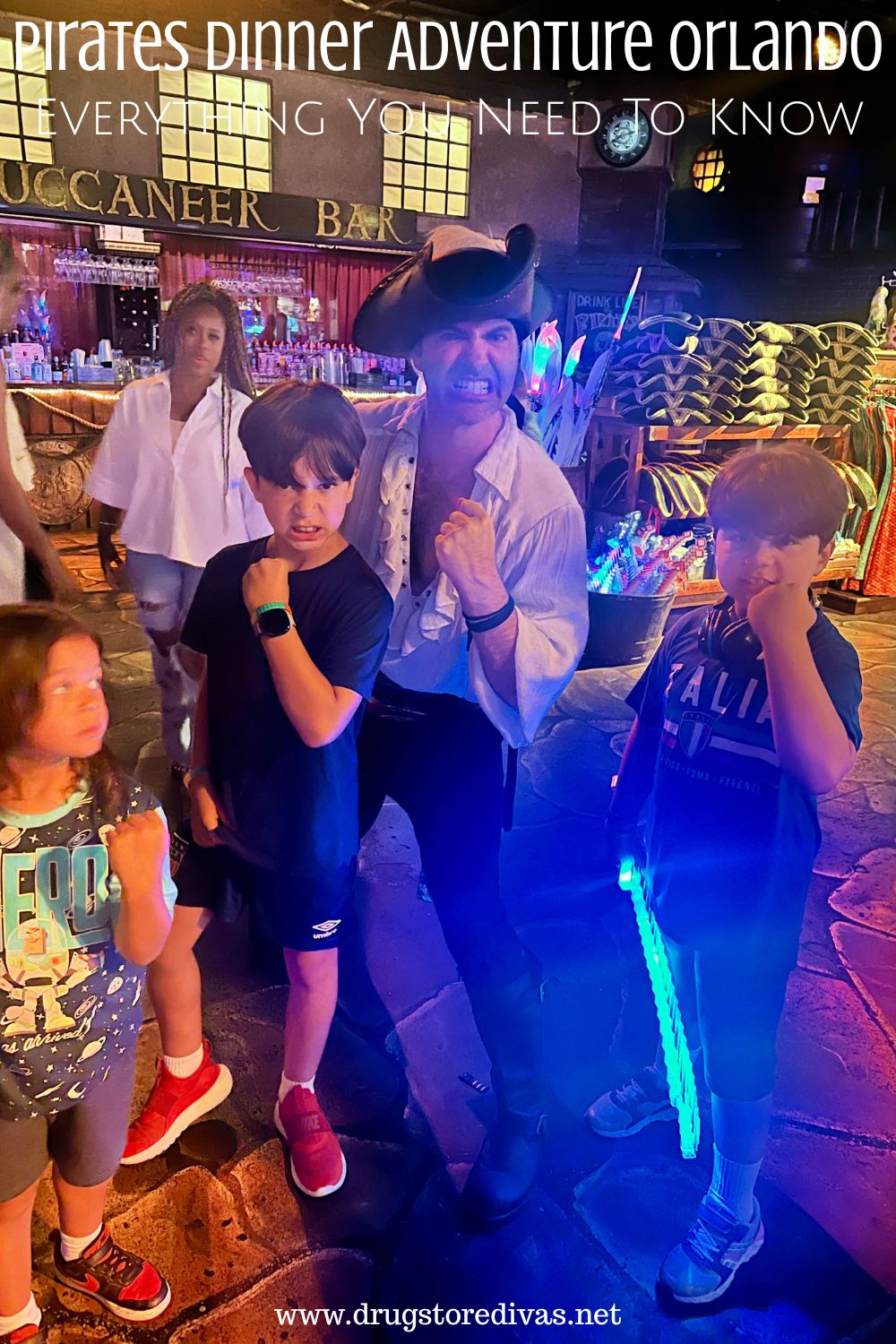 Three boys posing with a pirate actor with the words 