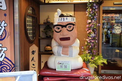 A statue of a sushi chef in white outside of Ganko Sushi in Dotonbori Japan.