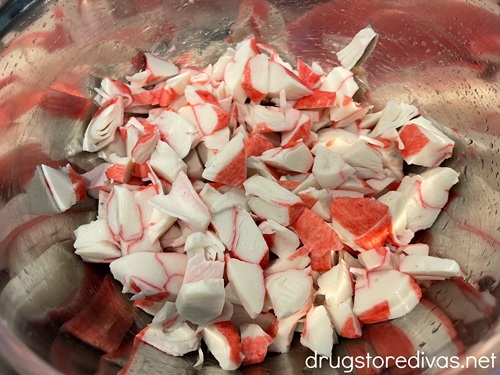 Imitation crab pieces in a silver bowl.