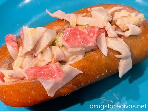 A crab roll on a blue tray.