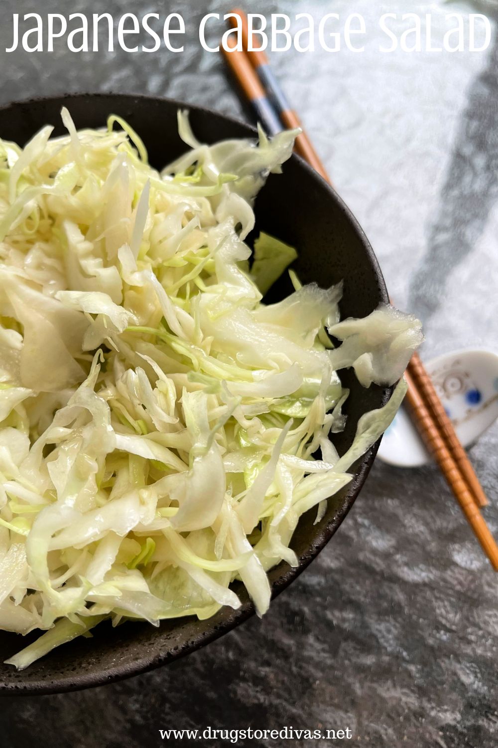 Shredded cabbage in a bowl with chopsticks next to it with the words 