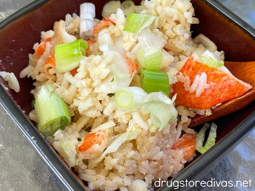 Kani yakimeshi (crab fried rice) in a black, square bowl.