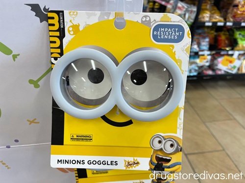 A pair of Minions goggles in a package on a shelf.