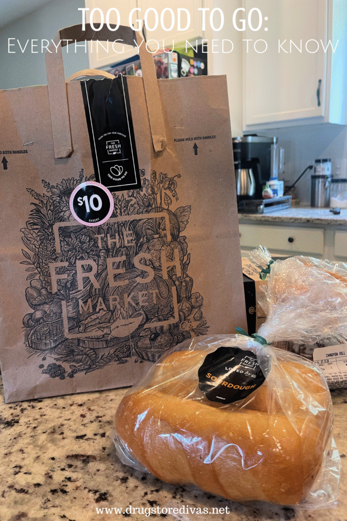 A brown bag from The Fresh Market grocery store with a $10 sticker on it and packaged bread in front with the words "Too Good To Go: Everything you need to know" digitally written on top.
