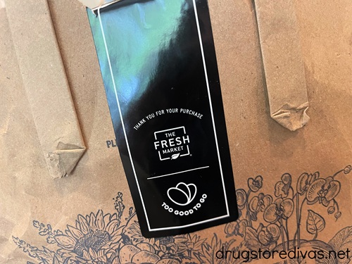 A brown bag with a black Too Good To Go sticker on it.