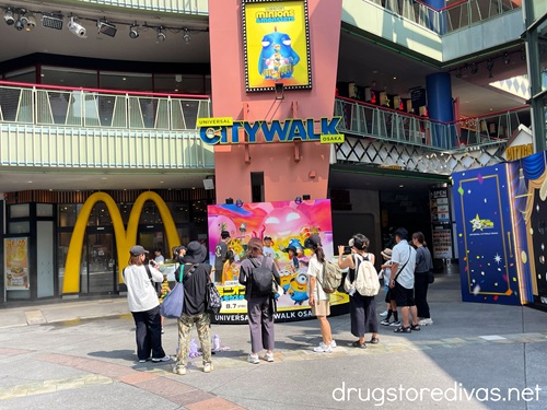 A group of people around a Minions display in Universal Citywalk Osaka.