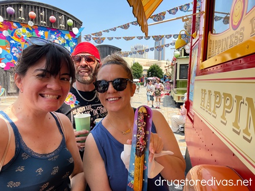 A man and two women posing with a churrito at Universal Studios Japan.
