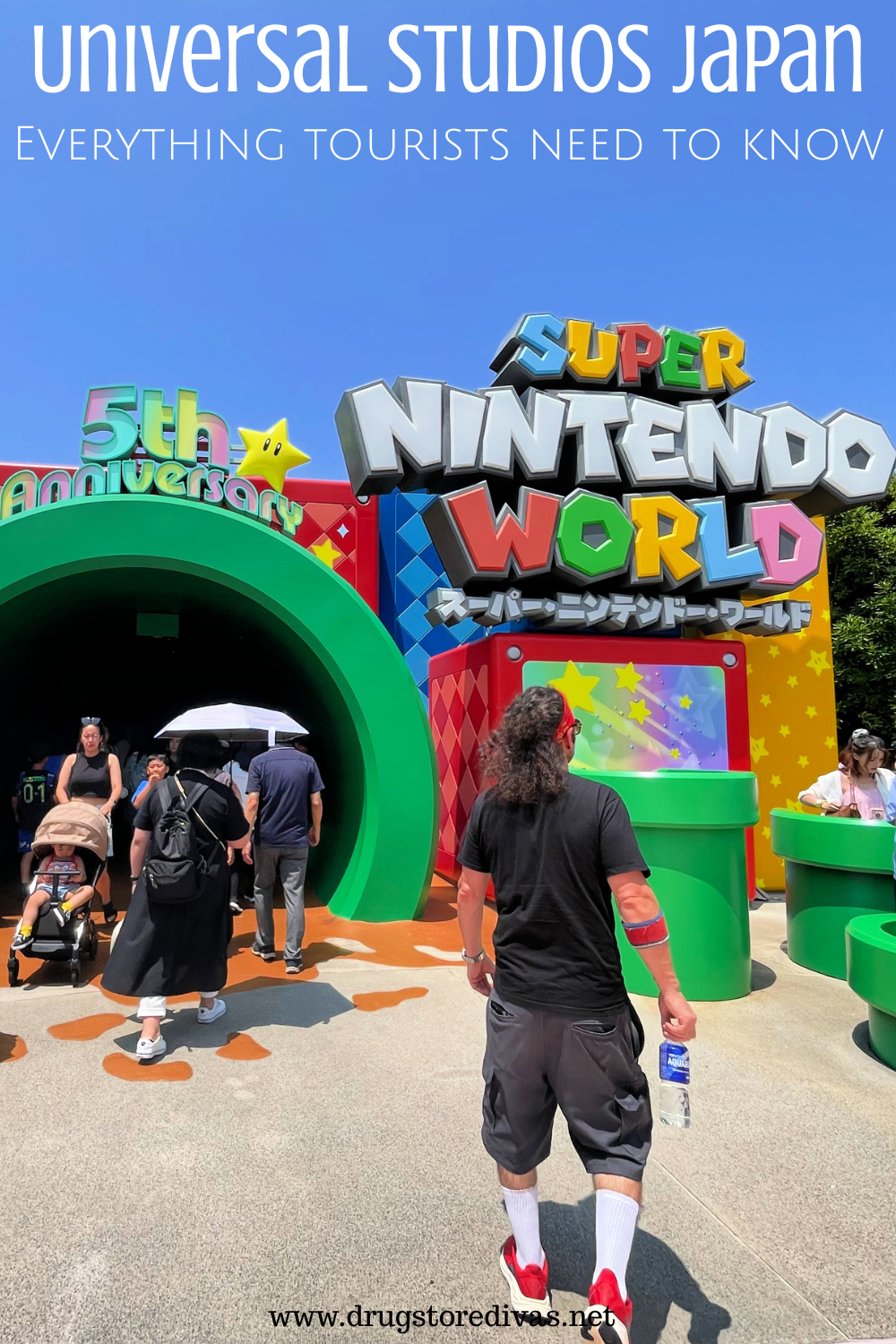 A man walking into Super Nintendo World at Universal Studios Japan with the words 