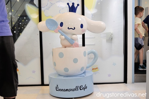 A statue of Cinnamoroll in a coffee cup holding a spoon at the Cinnamoroll Cafe in Osaka.