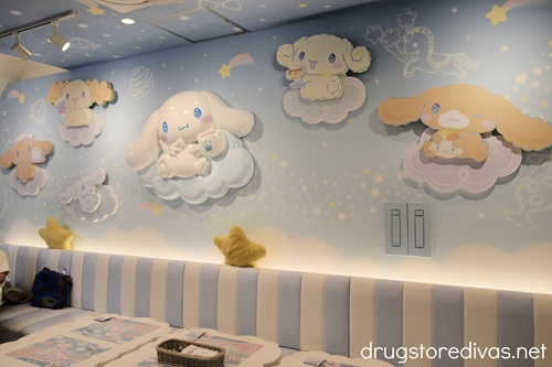 A cloud painted room with Cinnamoroll characters on the wall at the Cinnamoroll Cafe in Osaka.