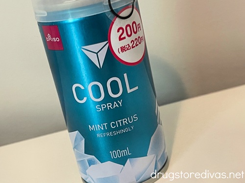 A blue tube of Cool Spray from a Daiso store sitting on a white table.