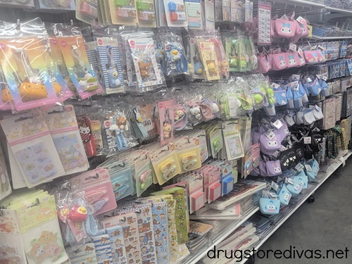 The stationery aisle in a Daiso store, showing keychains, stickers, and more.