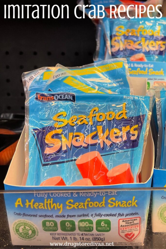Packages of imitation crab sticks, called Seafood Snackers, in a box on a shelf with the words "Imitation Crab Recipes" digitally written on top.