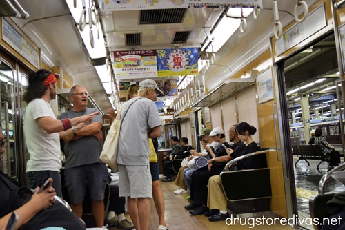 People on a subway train in Japan.
