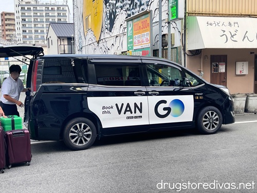 A Taxi Go van on a street in Japan.