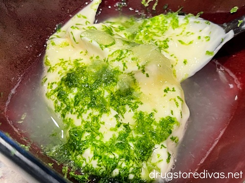 Mayo, lime zest, and lime juice in a maroon bowl.