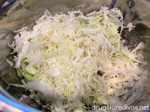Shredded cabbage in a silver bowl.