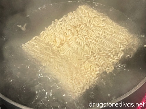 Instant ramen in a pot of boiling water.