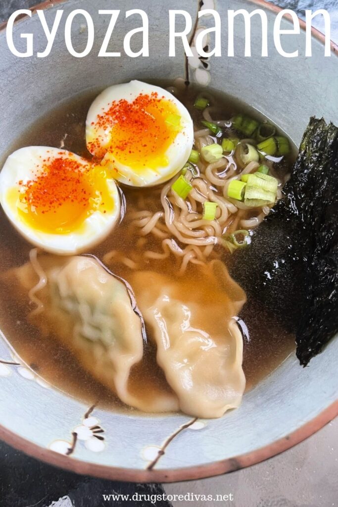 A bowl of soup with ramen noodles, gyoza, a jammy egg, seaweed, and green onions with the words "Gyoza Ramen" digitally written on top.