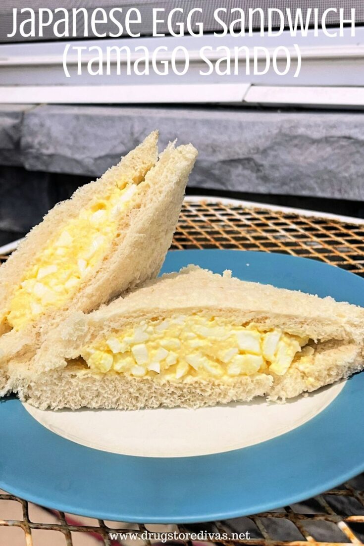 Two slices of egg salad sandwich on a blue and white plate with the words 