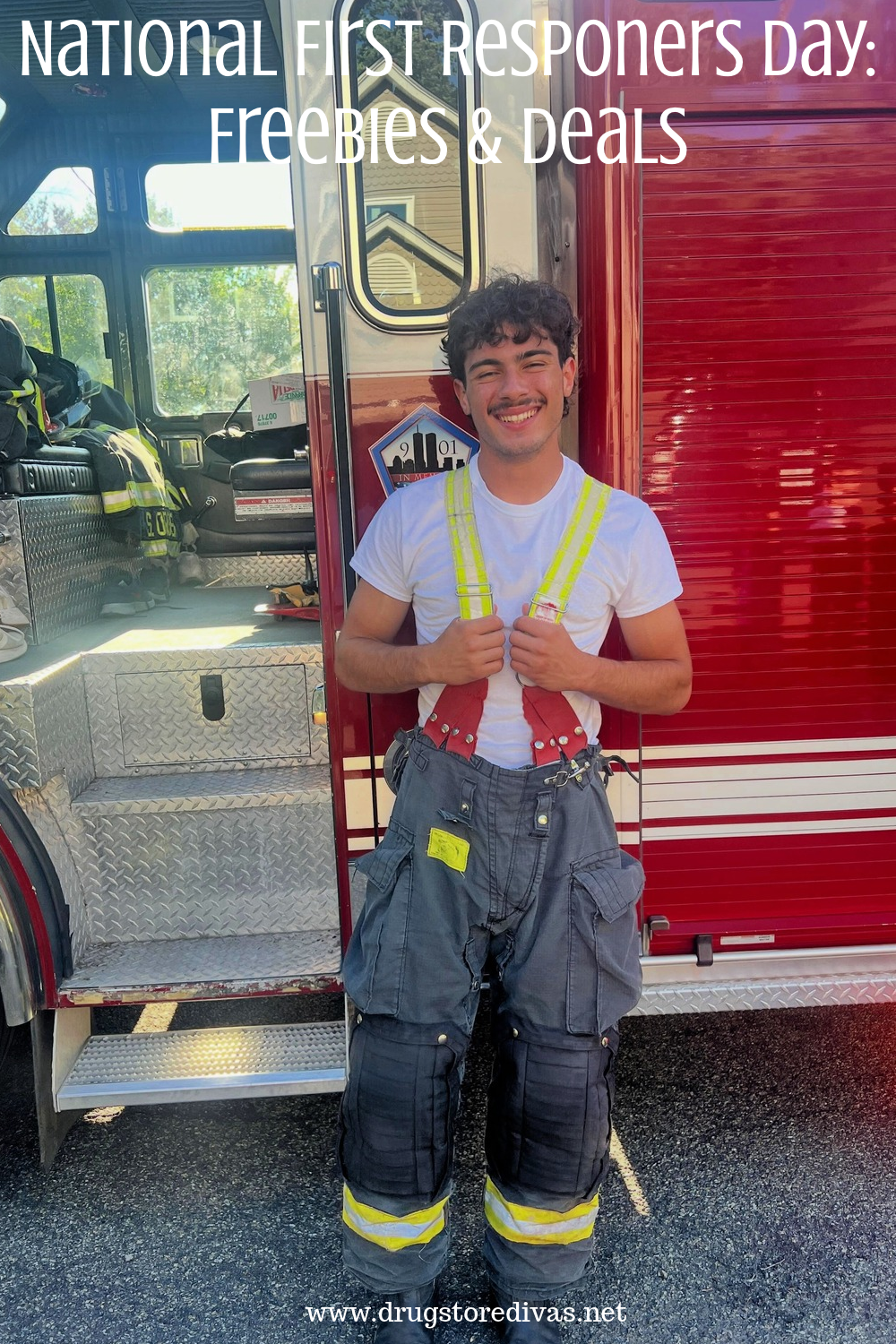 A teenage boy in a fireman's uniform in front of a fire truck with the words 